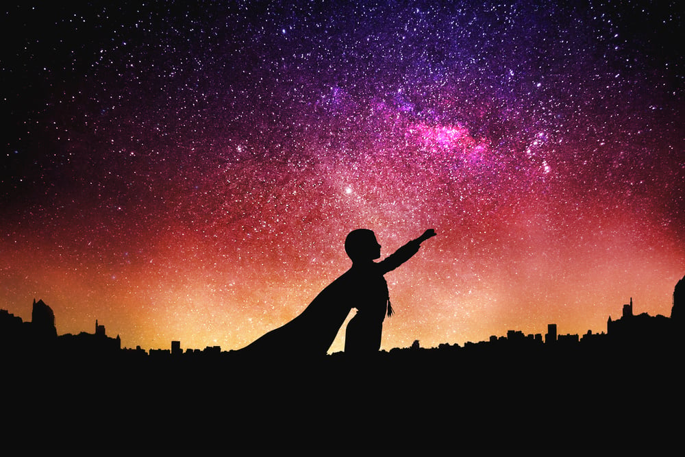 Superhero Silhouette at the Night Starry Sky Background